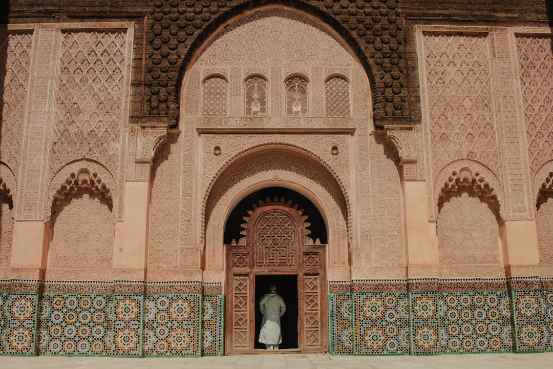 Riad doorway in the Marrakech médina, traveller stepping into the courtyard